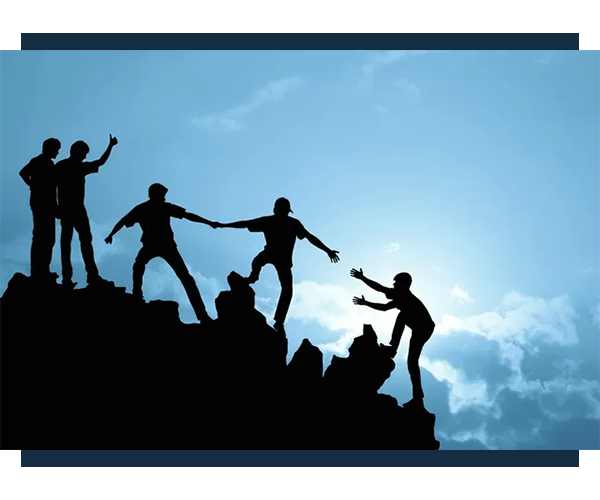 A group of people standing on top of a hill.